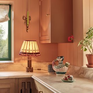 Italian inspired kitchen with wall cupboard, candle on wall and lamp on marble worktop neptune