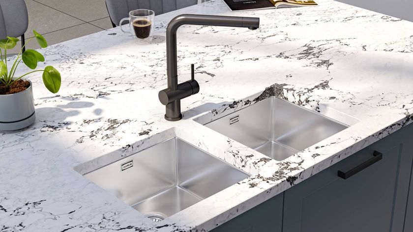 white marble island with stainless steel sinks and black tap