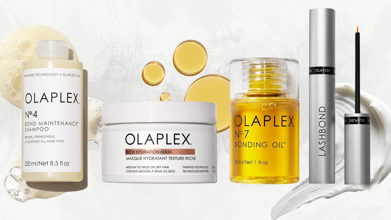 Lineup of Olaplex products, including No.4 Shampoo, Rich Hydration Mask, No.7 Oil and Lash Serum, on a white marble background with cream and oil swatches