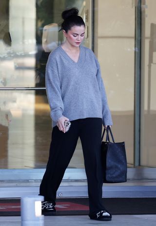 Selena Gomez wearing a gray sweater