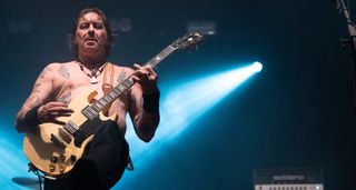 Matt Pike plays his white Gibson SG onstage at Primavera, under a blue spotlight