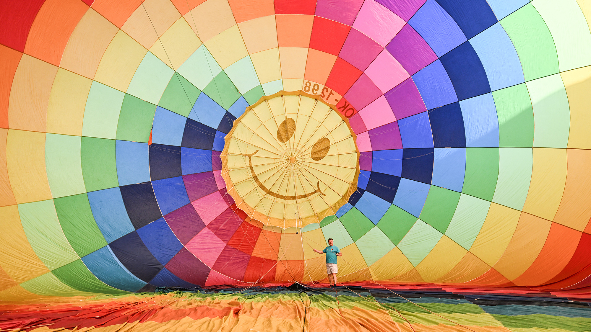 A man prepares a colorful hot-air balloon prior to the start of a balloon fiesta in Hradec Kr&amp;aacute;lov&amp;eacute;, Czech Republic