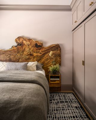 a bedroom with a live edge wood headboard