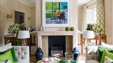 living room with antique style mirror accent walls either side of chimney breast and antique console tables sat in front