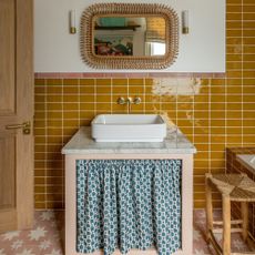 sink with curtain and mustard tiles