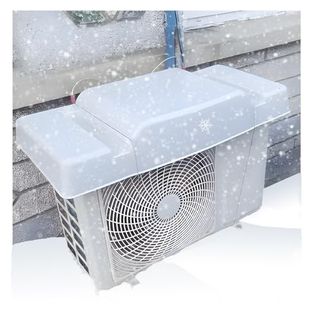 A white hard shell roof cover over an outdoor AC unit in the snow