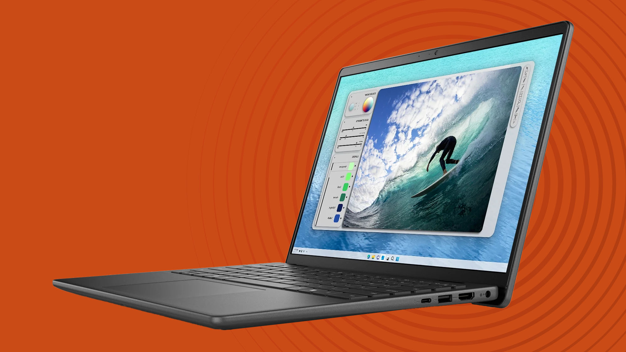 A Dell Inspiron 14 against an orange techradar background
