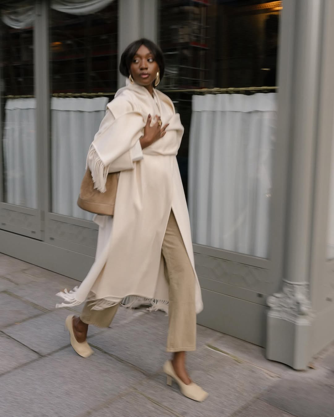 Emmanuelle wearing neutral outfit