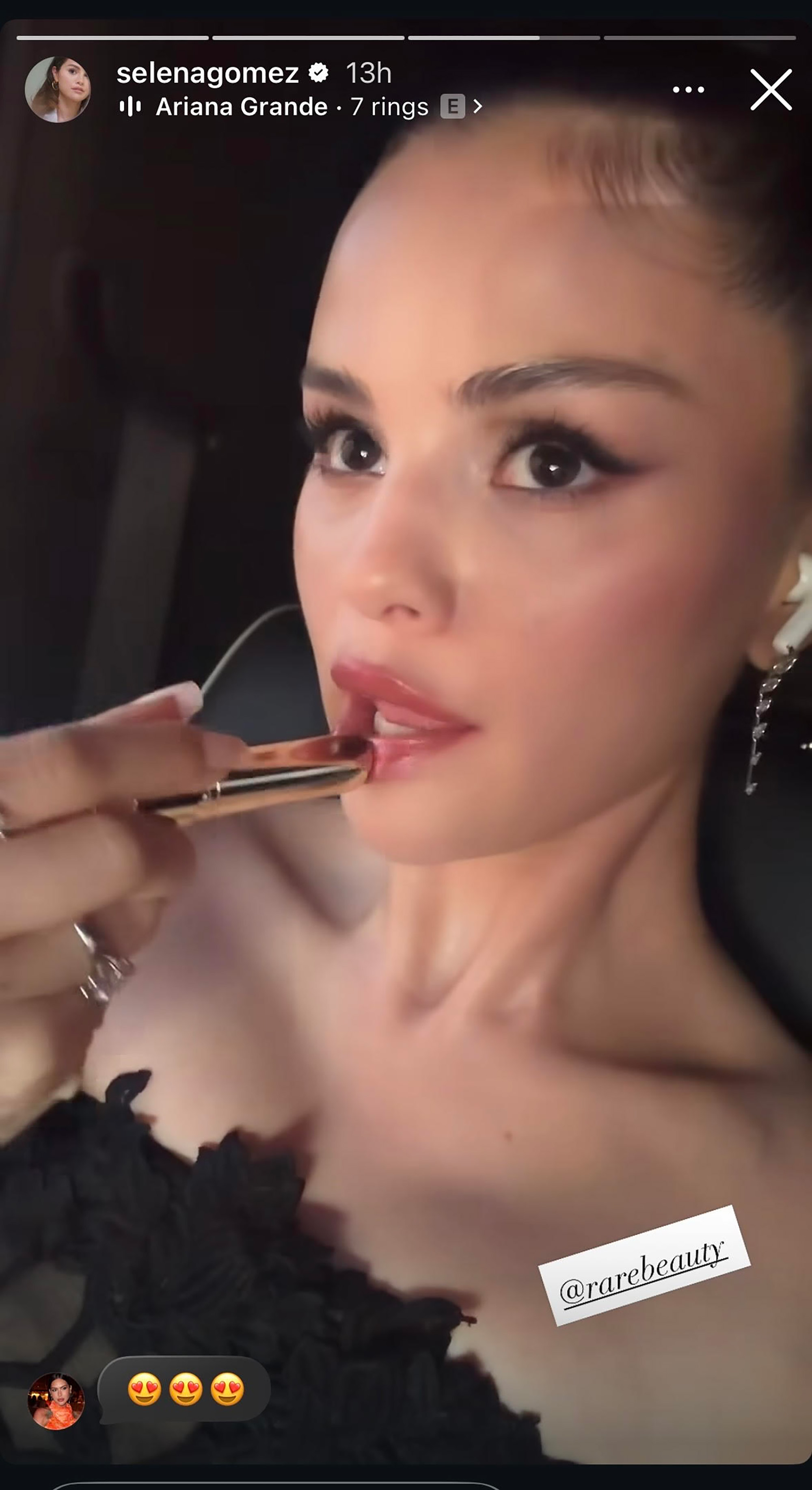 Selena Gomez tries on a new Rare Beauty lip product while wearing a black dress in a car on the way to what fans think is Taylor Swift's wedding.