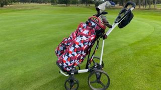 The flash Ogio All Elements Cart Bag and its excellent color patterns resting on the golf course