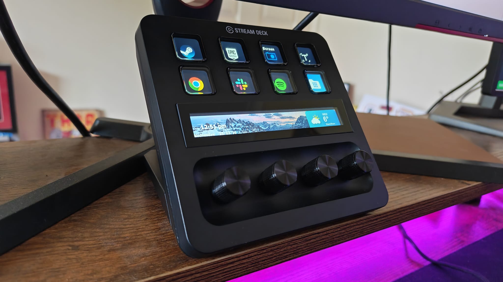 An Elgato Stream Deck Plus showing different application logos on its keys