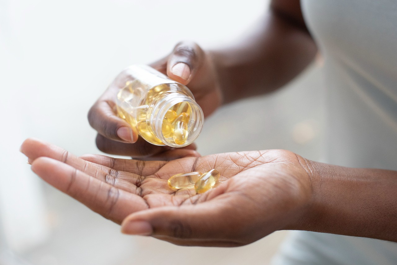 Woman pouring capsules into her hand