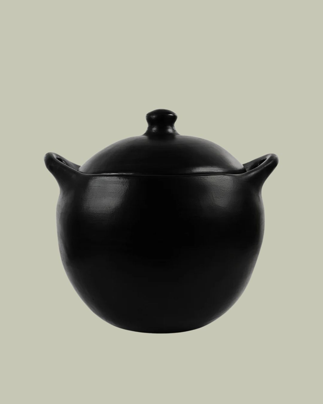 Chamba Black Clay Cocotte in Colombian Pottery against pale green background.