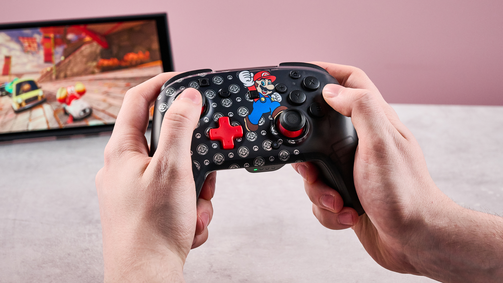 Man holding the Turtle Beach Rematch Wireless Controller for Nintendo Switch 2 and playing Mario Kart World