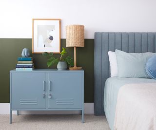 bedroom with blue headboard and side cabinet