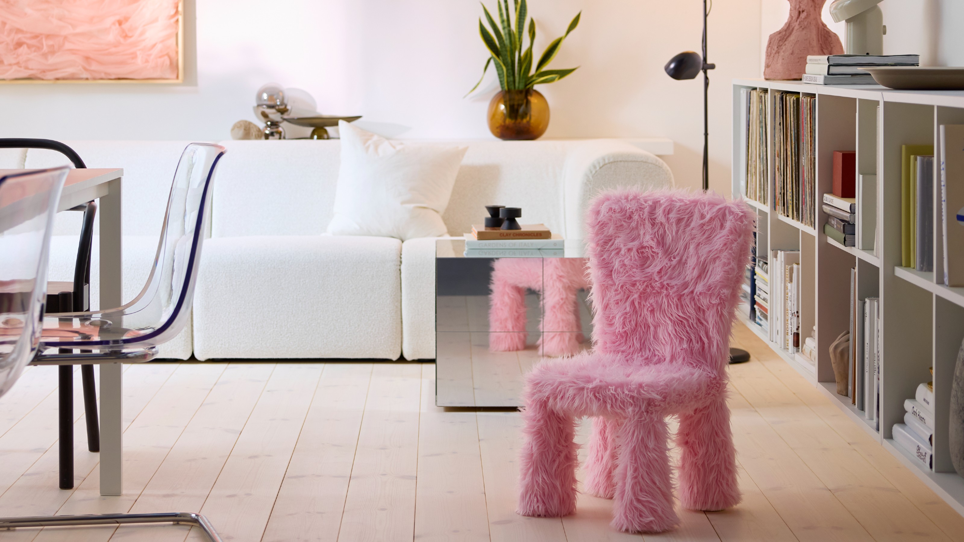 A modern minimalist living room with the IKEA MAMMUT kids&#039; chair covered in the brand&#039;s pink faux fur cover from the GREJSIMOJS collection