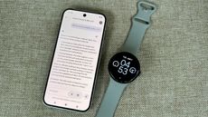 The Pixel 9 and Pixel Watch 3 sitting next to each other. The Pixel 9 shows the Gemini app with the query "Will Gemini be available on Wear OS?" with the answer speculating on recent news about a Gemini leak.