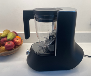 The Tiger blender on a white kitchen counter next to a fruit bowl