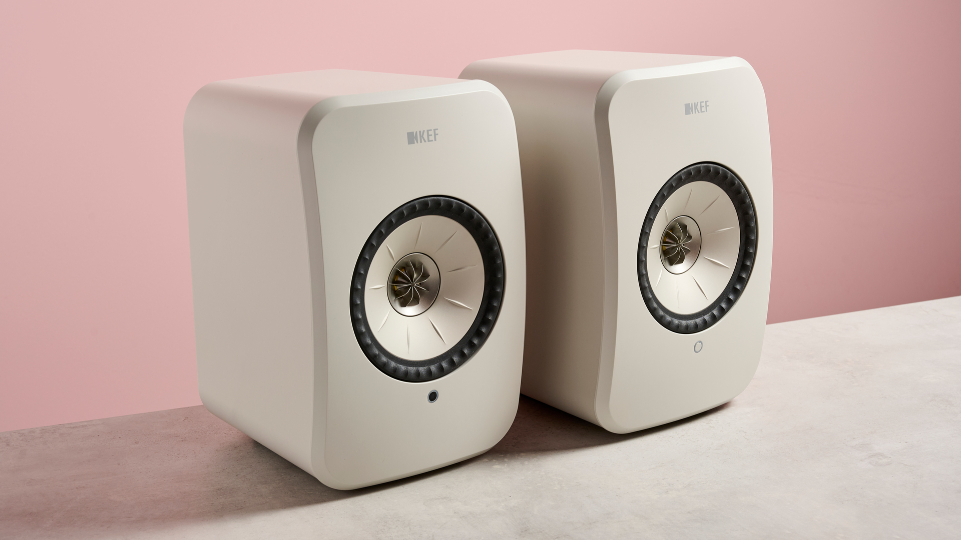 The KEF LSX II LT speaker against a pink background