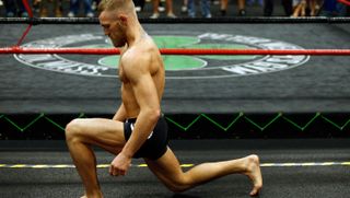 Conor McGregor performing a warm-up stretch