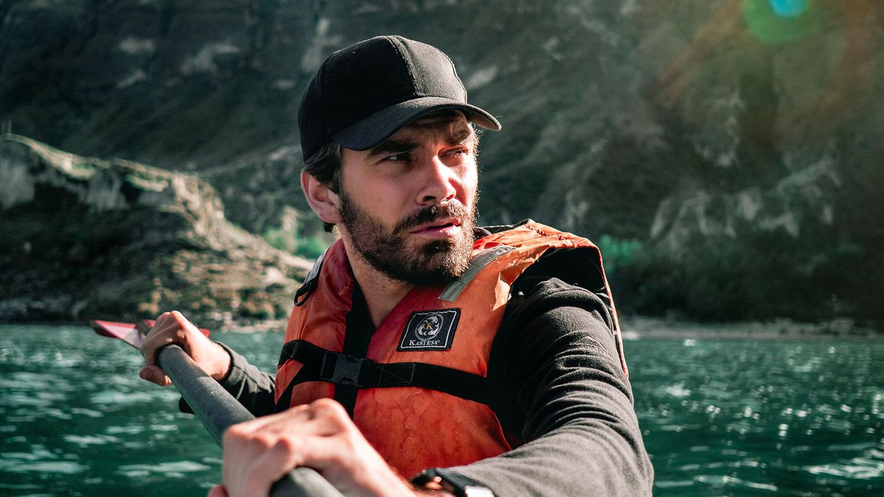 Person paddling while wearing a life jacket