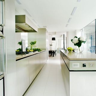 kitchen room with white tiled flooring and flower in vase