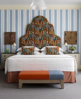 Striped blue bedroom with statement headboard