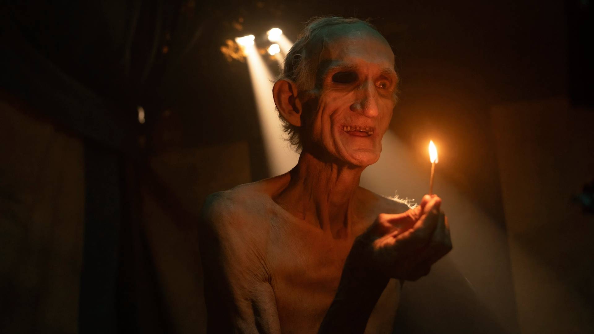 An old man holding a match in It: Welcome to Derry