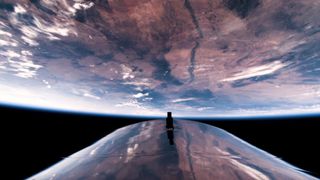 part of a shiny silver spacecraft with earth and the blackness of space in the background. 