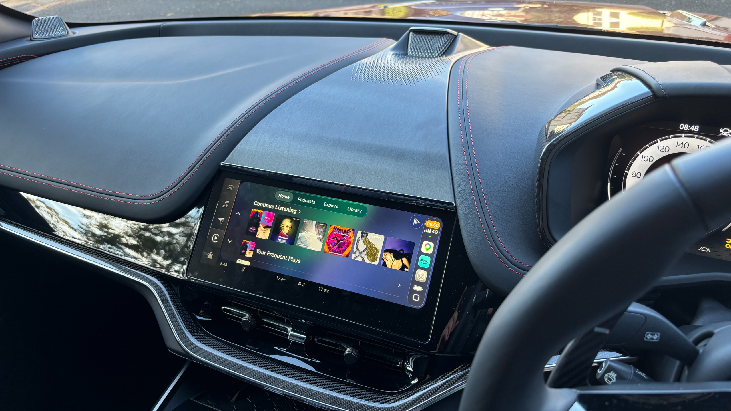 The interior view of an Aston Martin DBX S looking down on its infotainment touchscreen