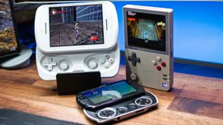 Anbernic RG Slide next to AYANEO Pocket DMG and PSP Go