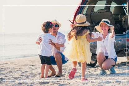 Parents with children enjoying vacation on beach