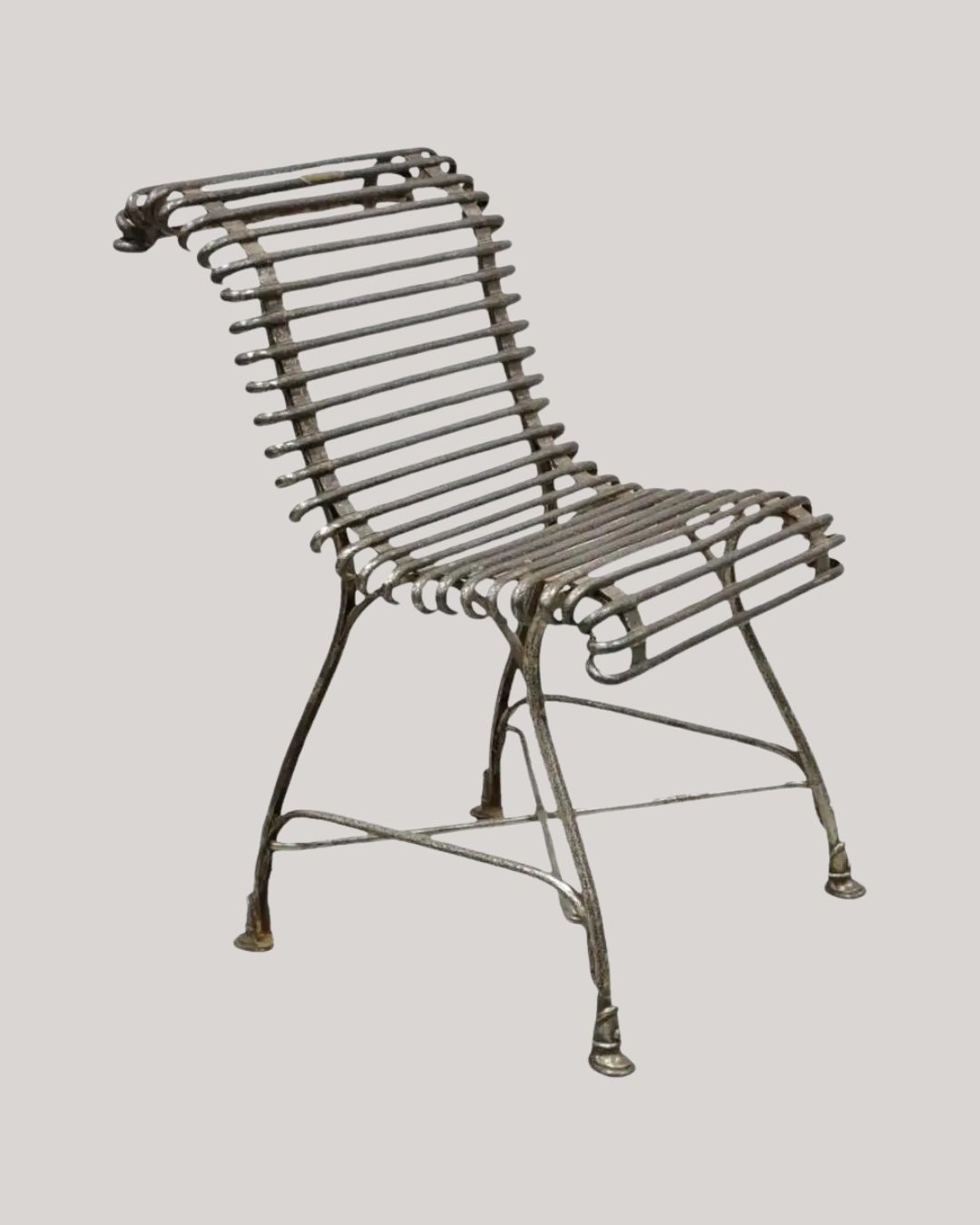 Antique Sauveur Arras French Wrought Cast Iron Spine Scrolling Garden Side Chair against pale gray background.