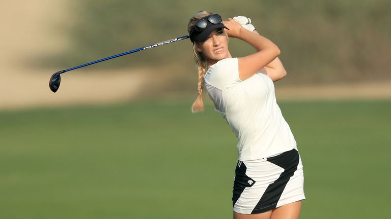 Paige Spiranac holds her finish after hitting a shot 