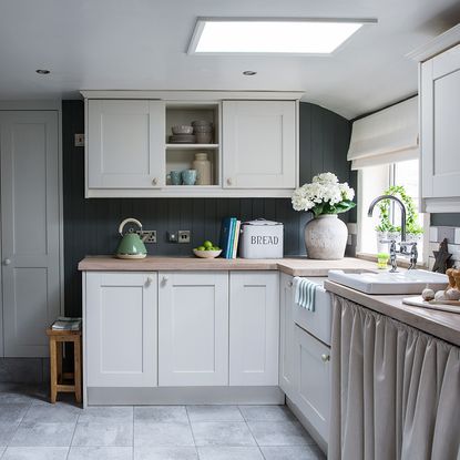 kitchen area with shaker style kitchen units and tiles floor