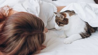 Woman and cat in bed