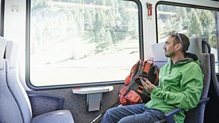 eco camping: backpacker on train