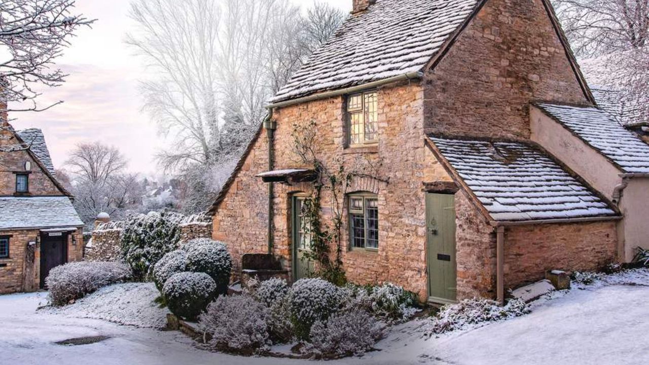 A traditional cottage and its frosty-covered front garden