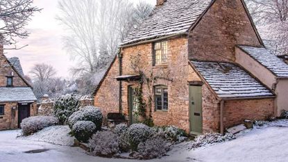 A traditional cottage and its frosty-covered front garden