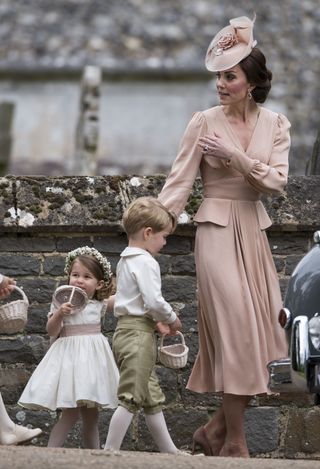 Catherine, Duchess of Cambridge with Prince George of Cambridge and Princess Charlotte of Cambridge attend the wedding of Pippa Middleton and James Matthews at St Mark's Church on May 20, 2017 in Englefield Green, England