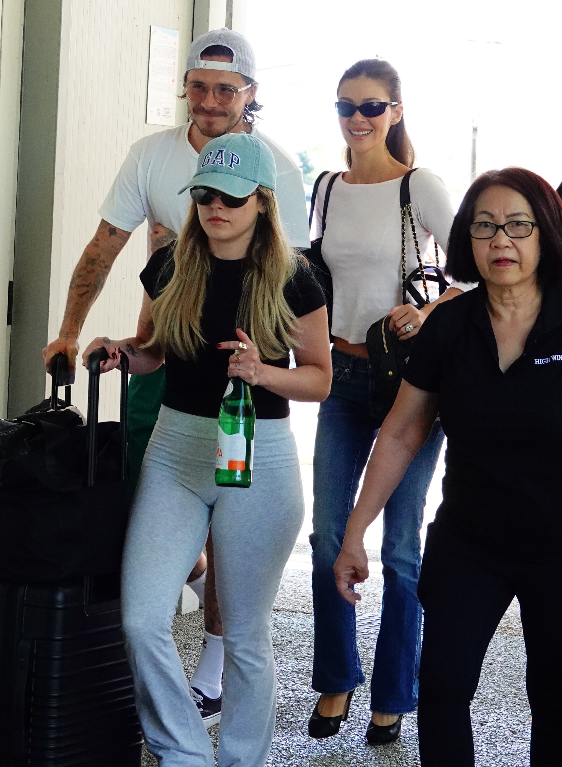 Nicola Peltz Beckham walks down the street in Venice wearing low-rise bootcut jeans.