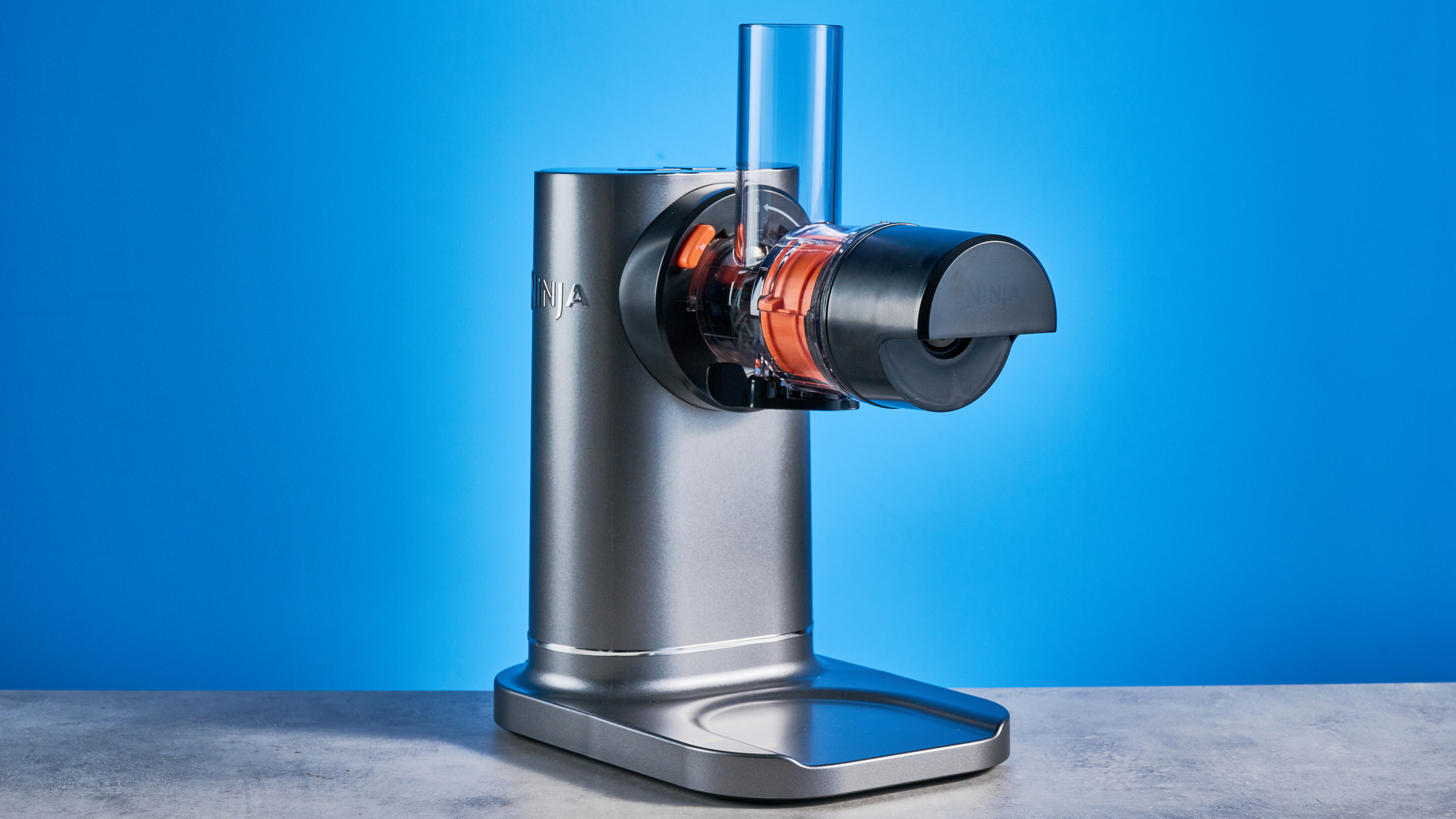 Ninja Cold Press Juicer photographed in front of a blue background