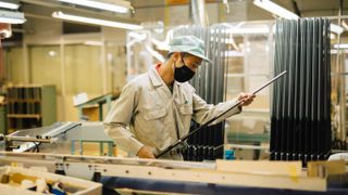 A man looking at a Yonex graphite shaft