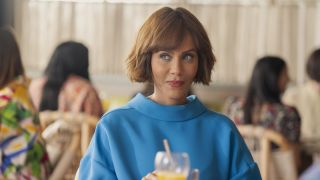 Nicole Ari Parker wearing blue dress and seated for brunch in And Just Like That...