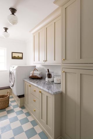 beige laundry room with built in cabinetry and pedestal