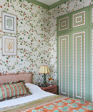 bedroom with patterned wallpaper and painted patterned inbuilt wardrobes