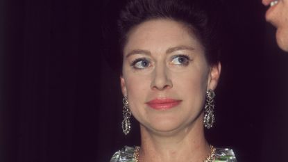  Princess Margaret (1930 - 2002) at the Royal Festival Hall after a Frank Sinatra concert in aid of the NSPCC, she is looking up at her husband Lord Snowdon. 