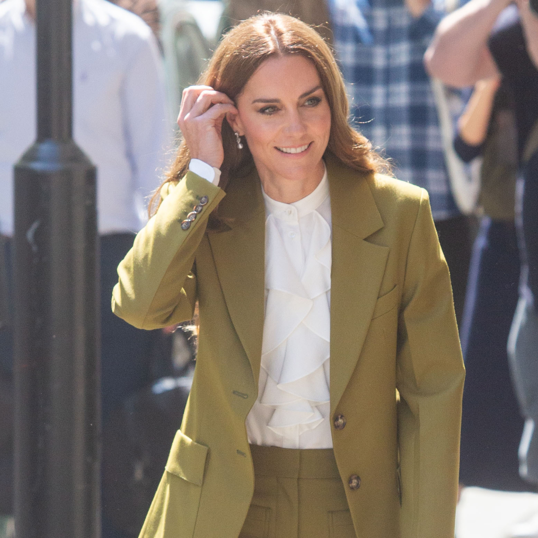 Kate Middleton wearing an olive suit and white shirt
