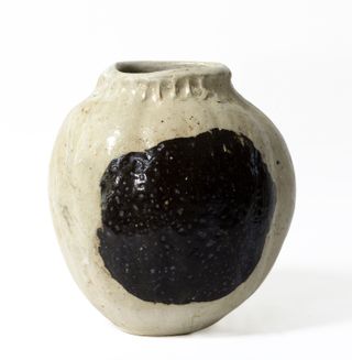 White glazed ceramic vase by Pierre Casenove featuring a black circular design