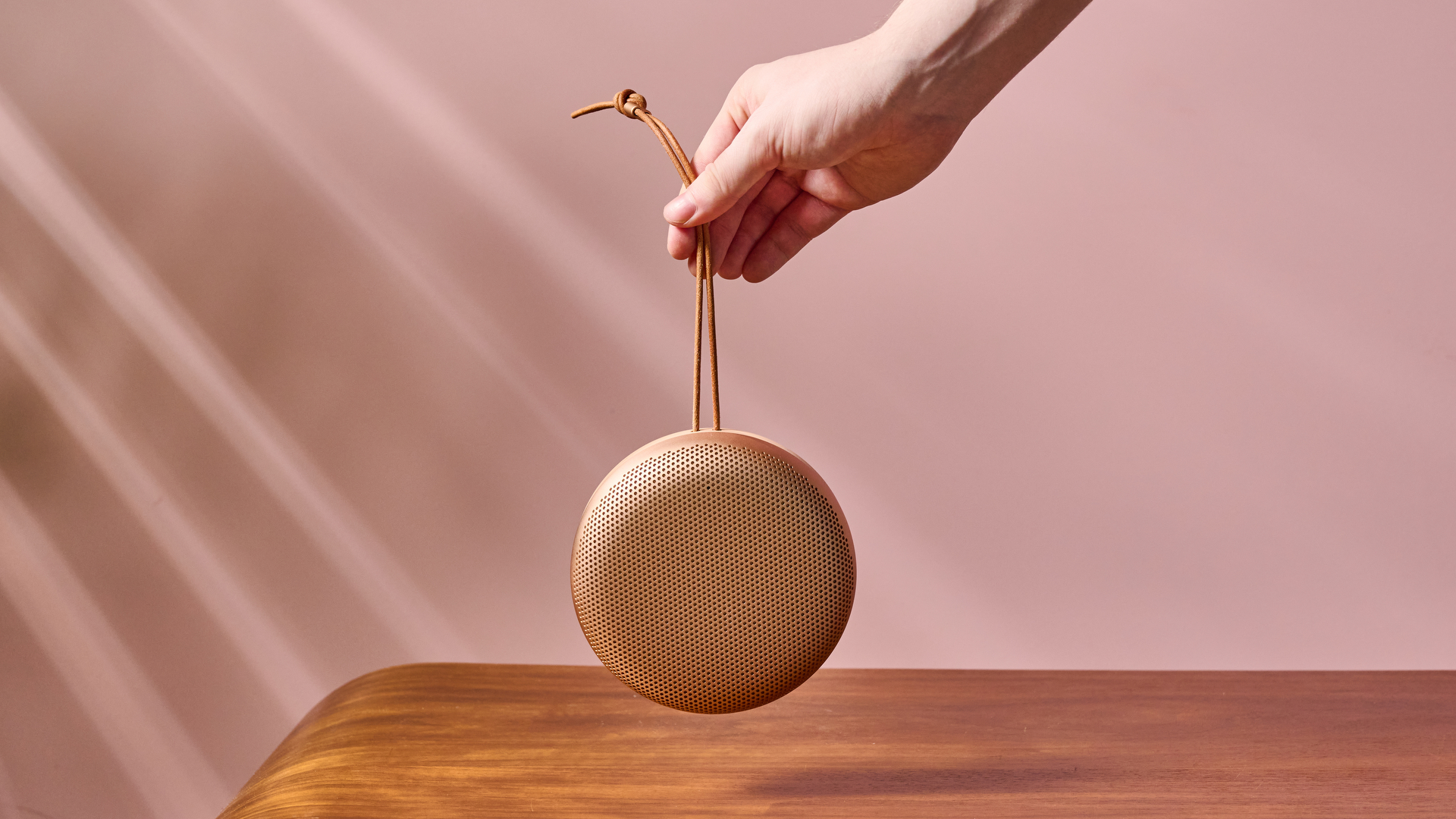 Man holding Bang & Olufsen Beosound A1 3rd Generation by carry strap